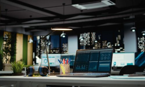 Luxurious modern office space with important reports on laptop, empty desk showcasing important data analytics and insight for management and business administration tasks. Forecasting.